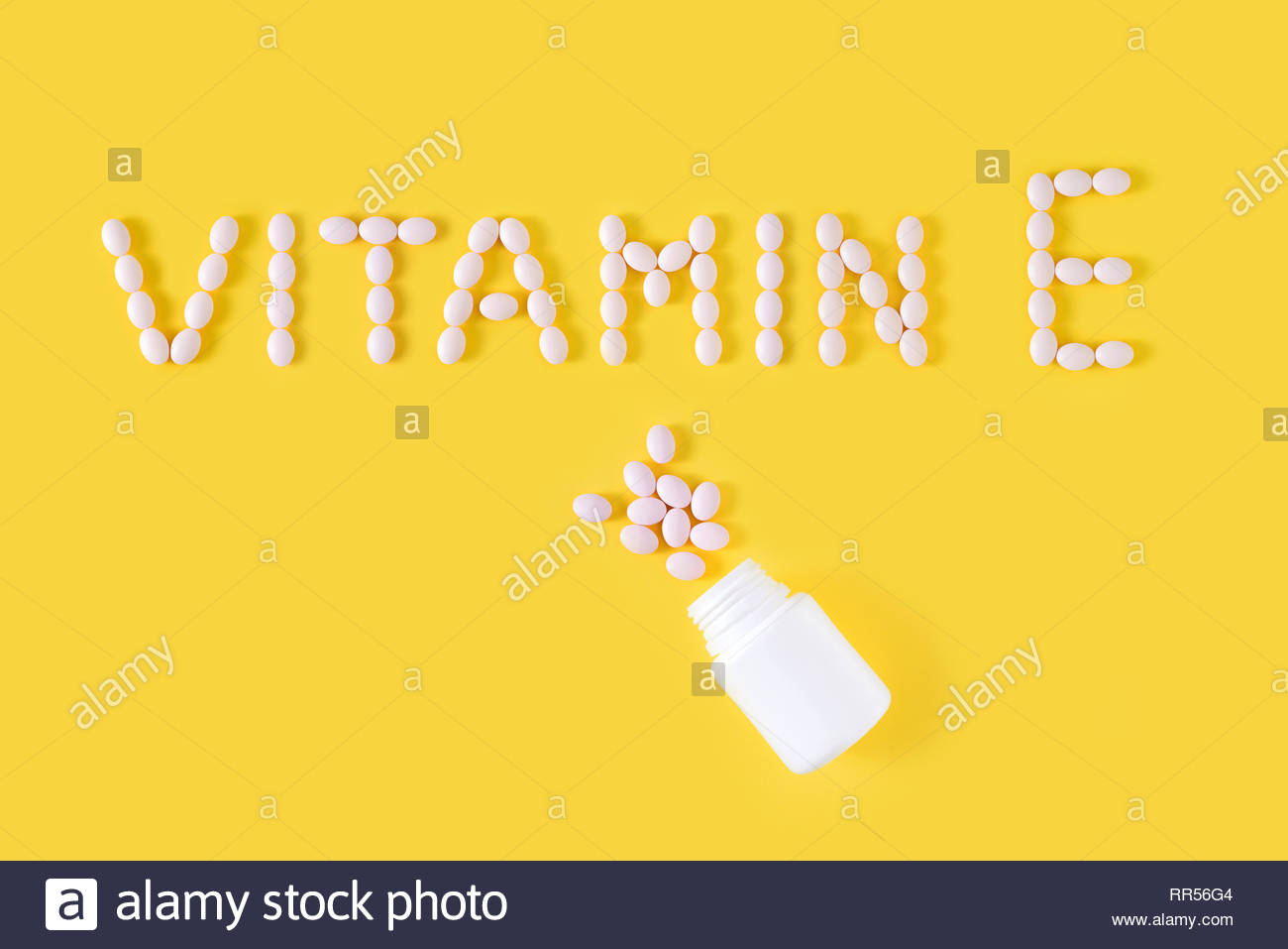 Vitamin E Pills Dropped From Bottle On Yellow Background Flat Lay