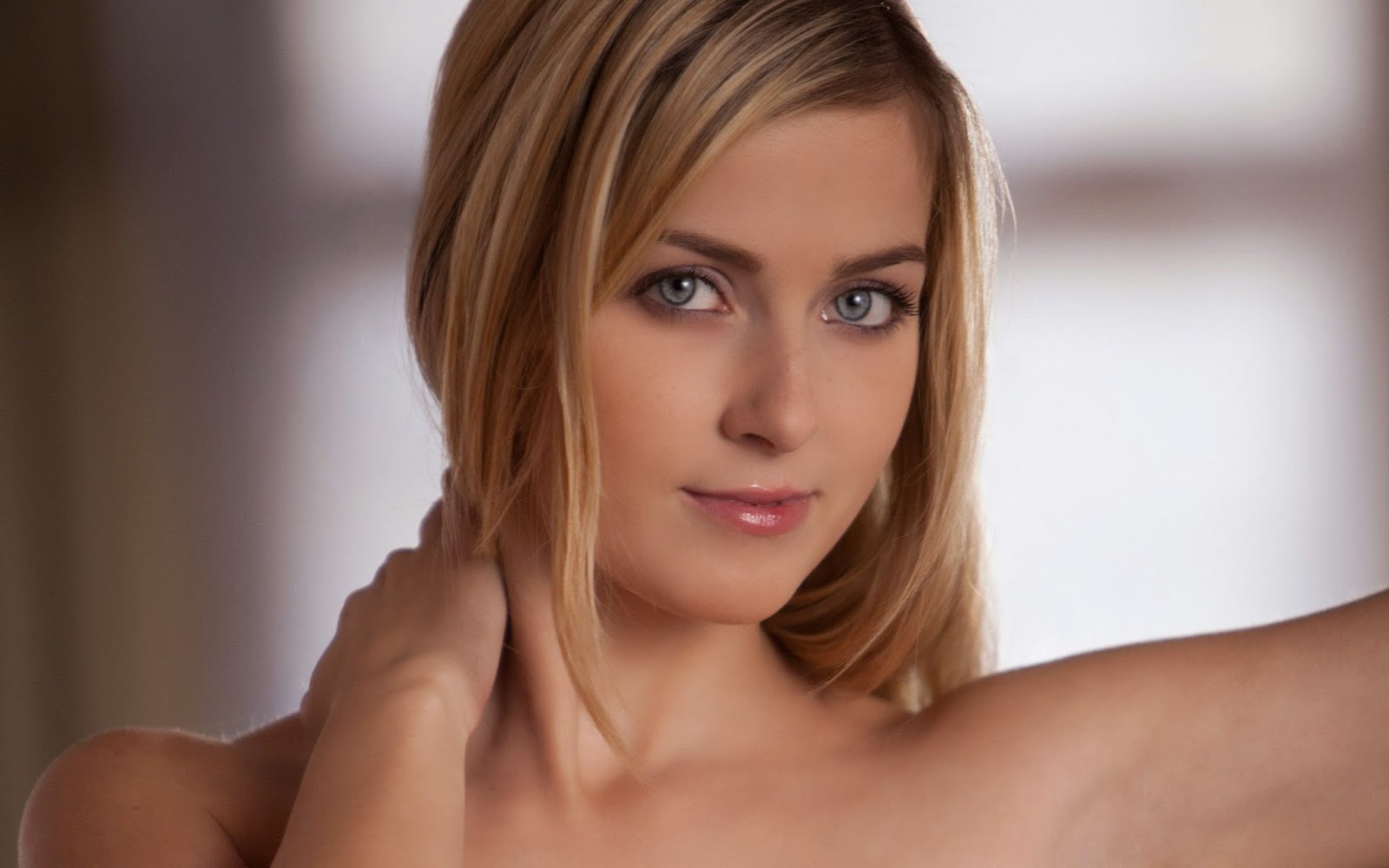 Close-up portrait of a beautiful blonde woman with captivating blue eyes