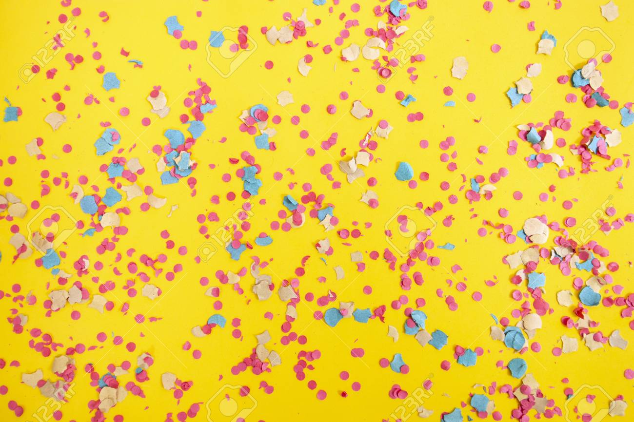 Mixed Colorful Confetti Scattered On A Yellow Background Stock