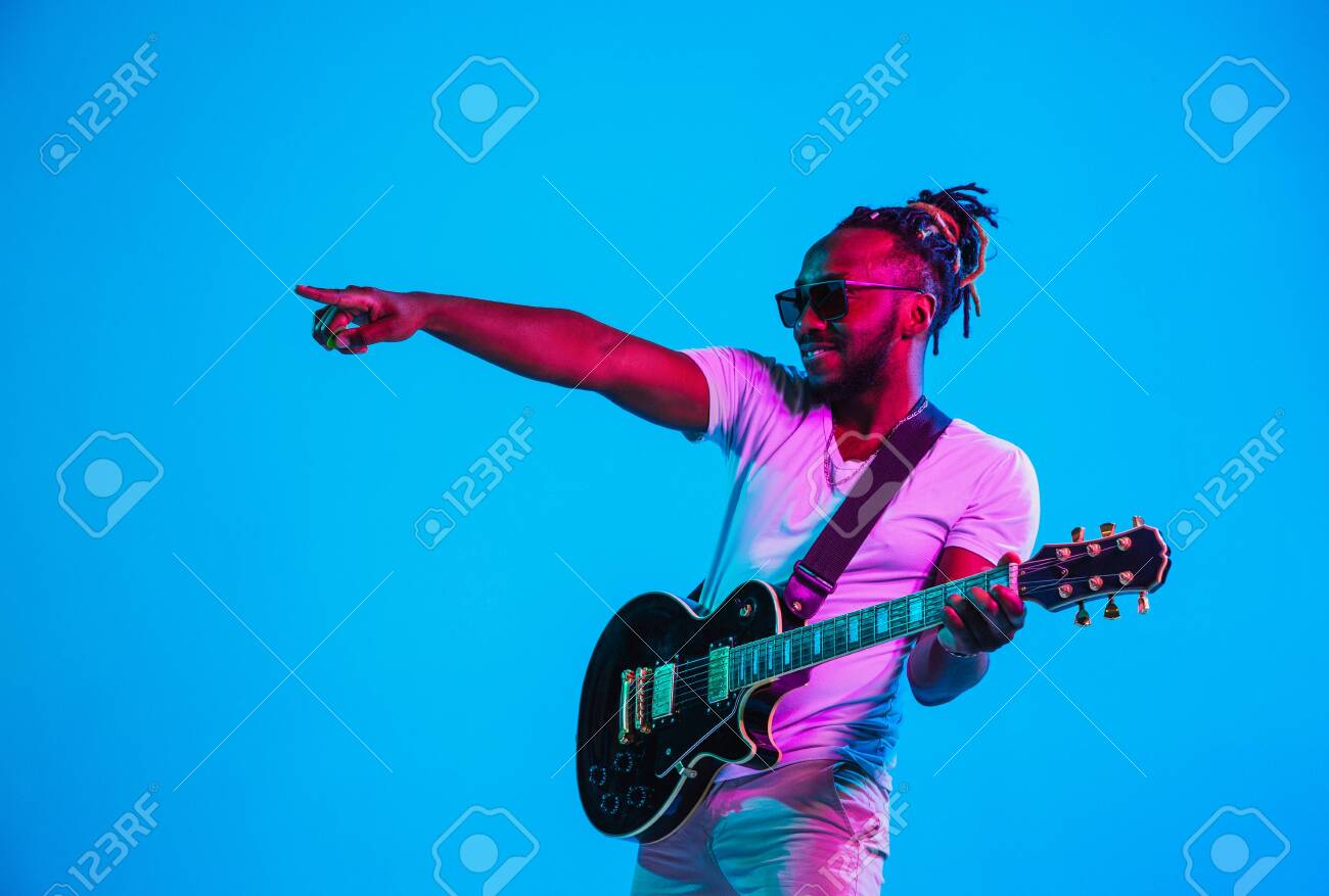Young African American Musician Playing The Guitar Like A Rockstar