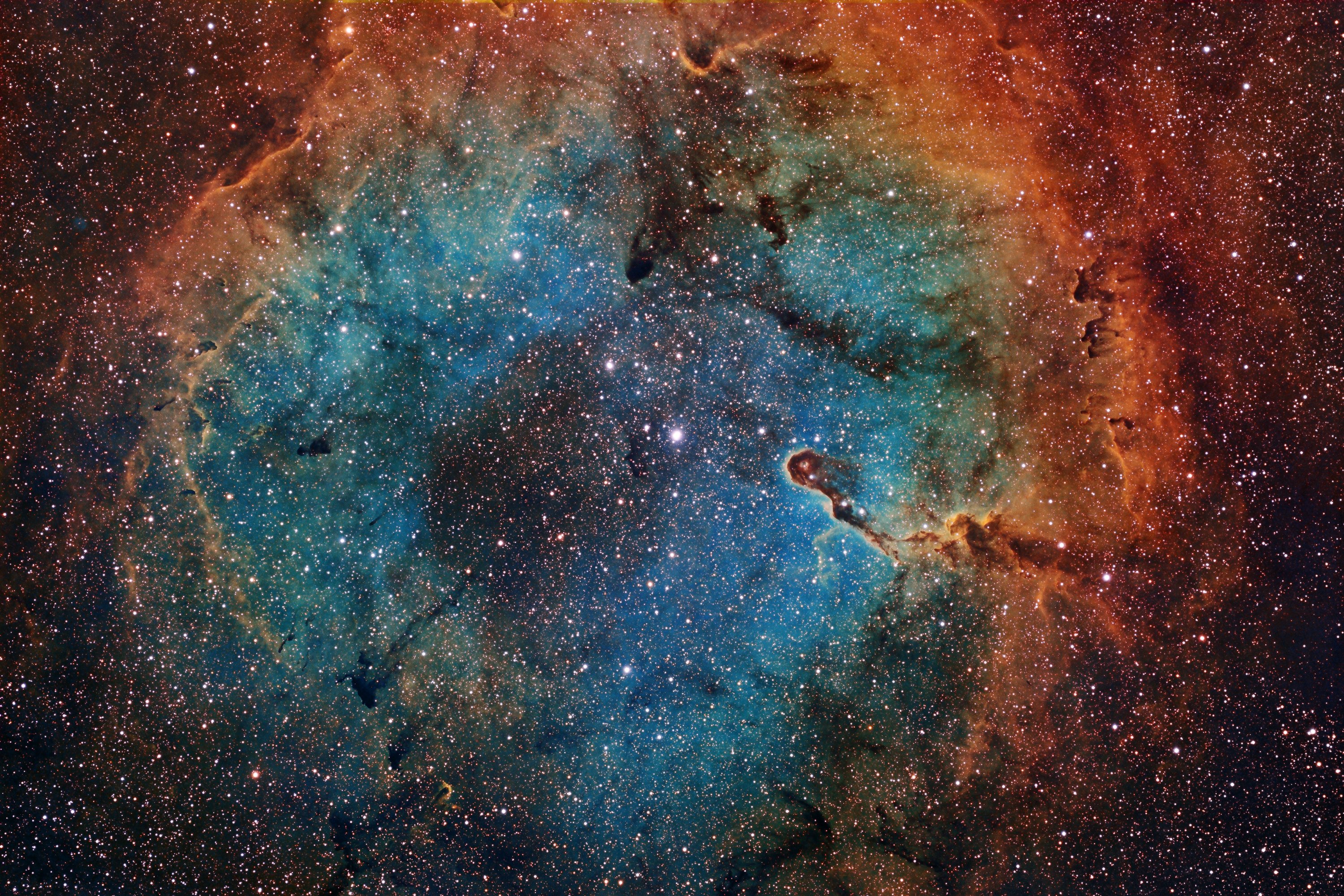 A breathtaking view of the cosmos, featuring a vibrant nebula with swirling clouds of gas and dust, illuminated by countless stars