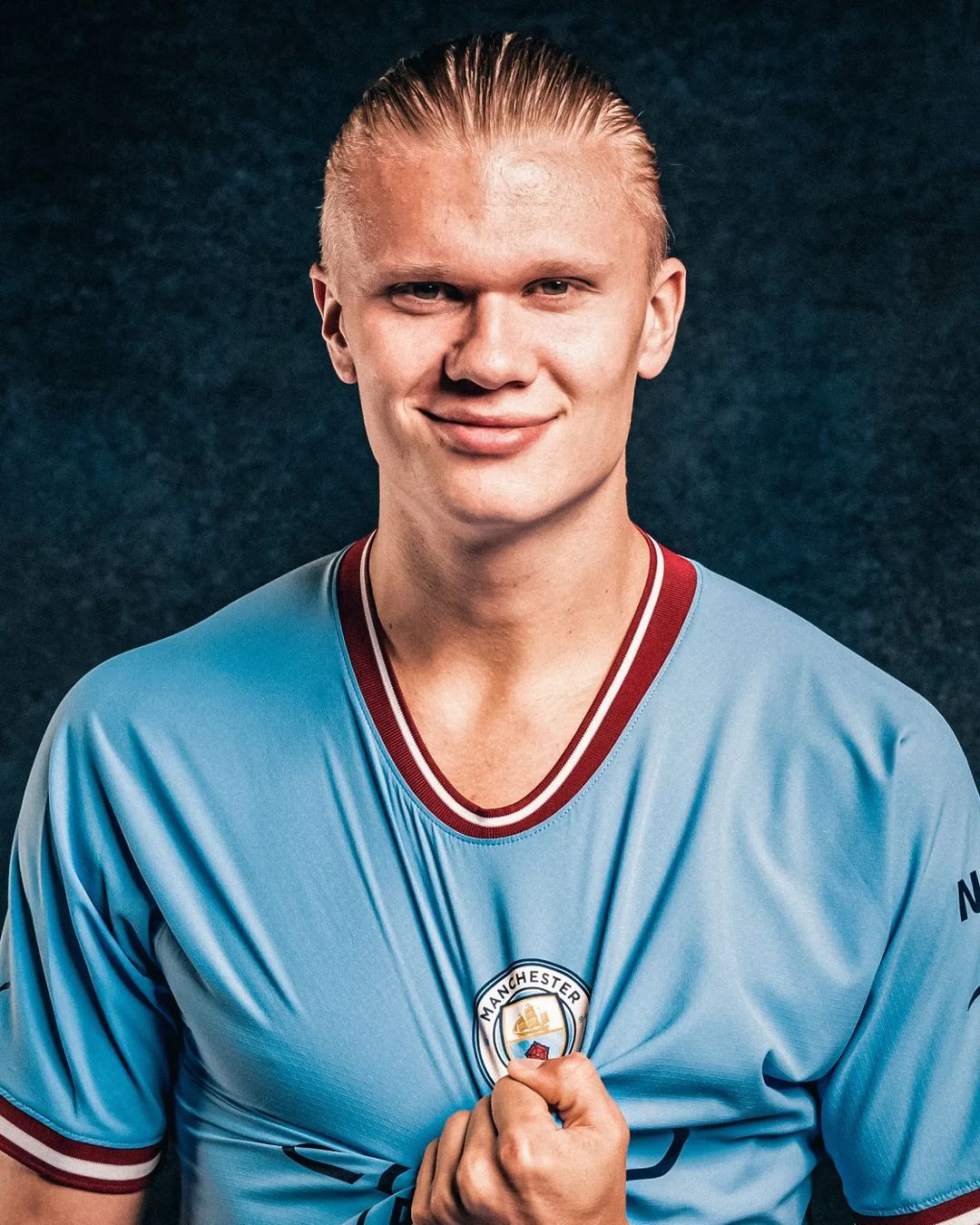 A portrait of Erling Haaland, Manchester City footballer, in a light blue jersey