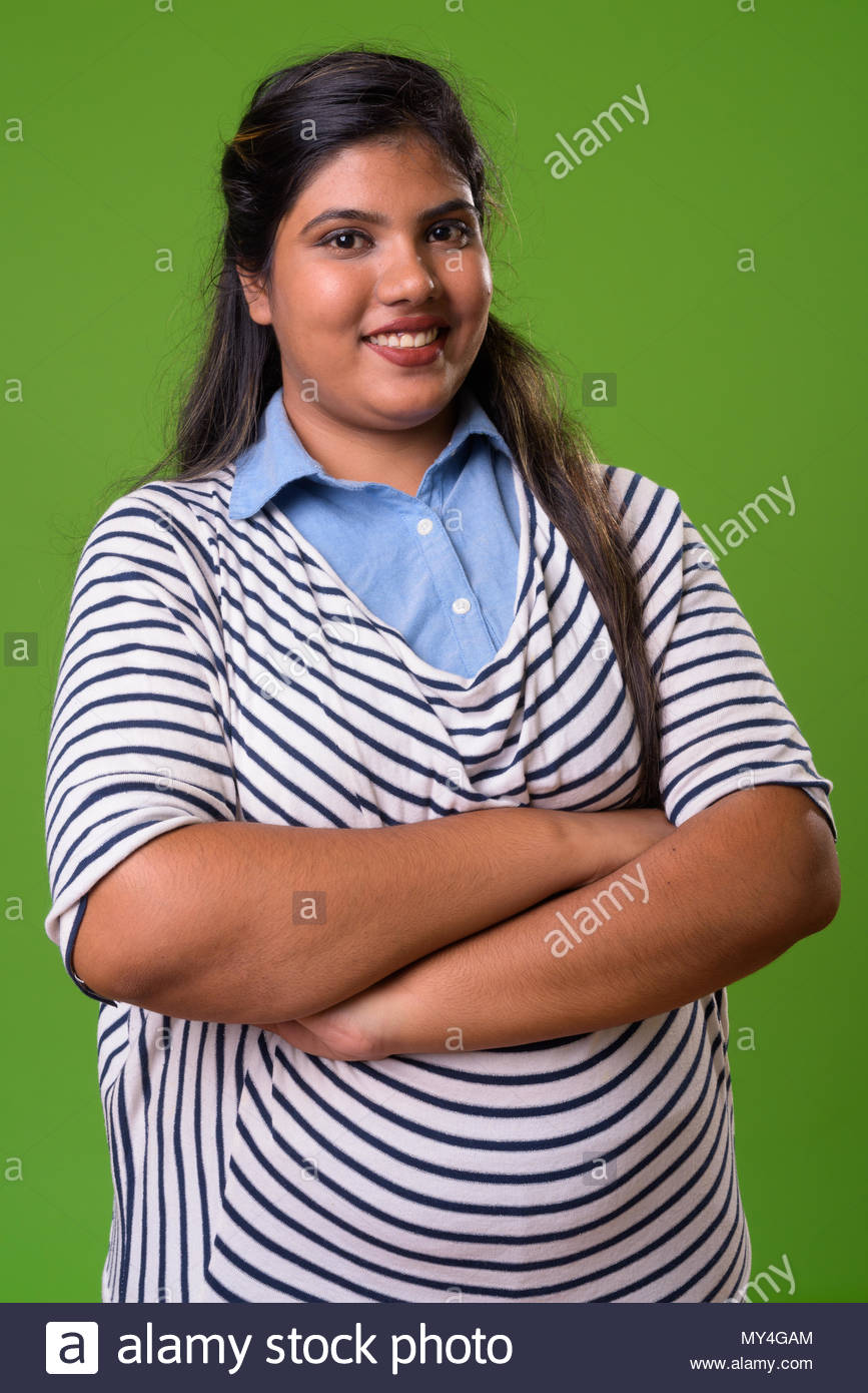 Young Overweight Beautiful Indian Businesswoman Against Green