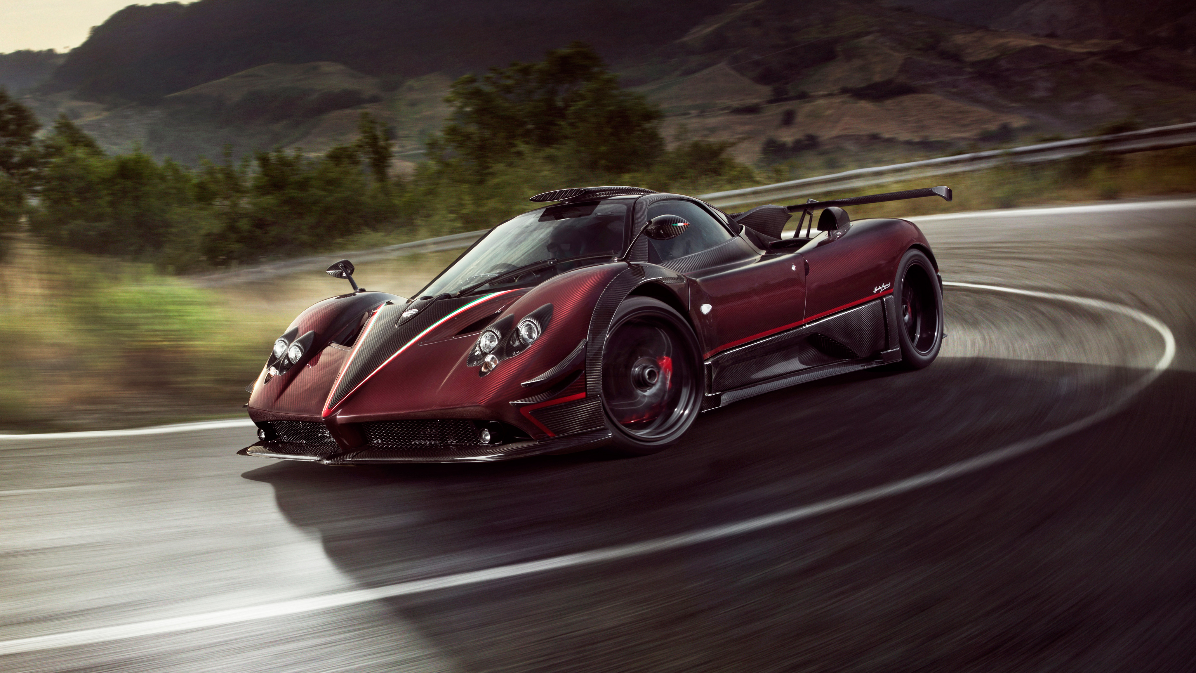 A Pagani Huayra supercar speeding around a corner on a race track