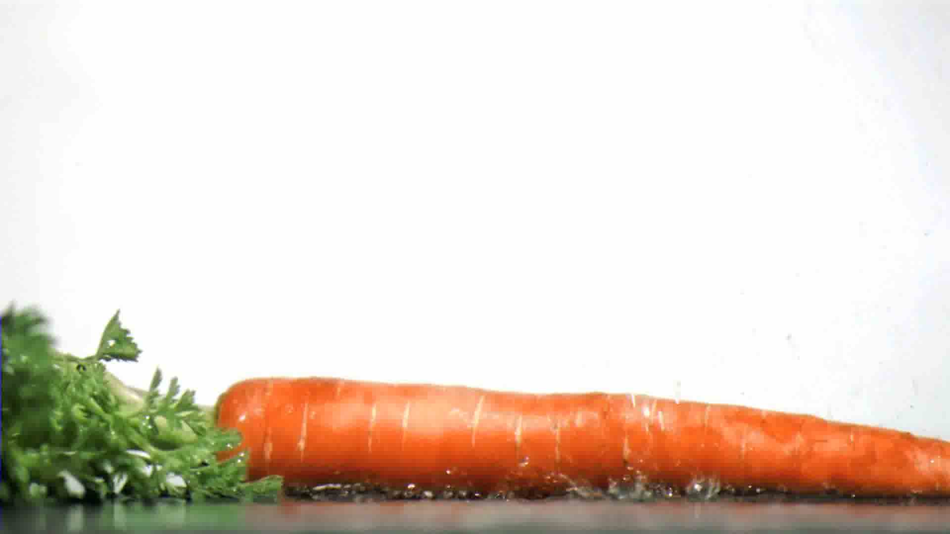 Tasty Carrot In Super Slow Motion Receiving Drops Royalty