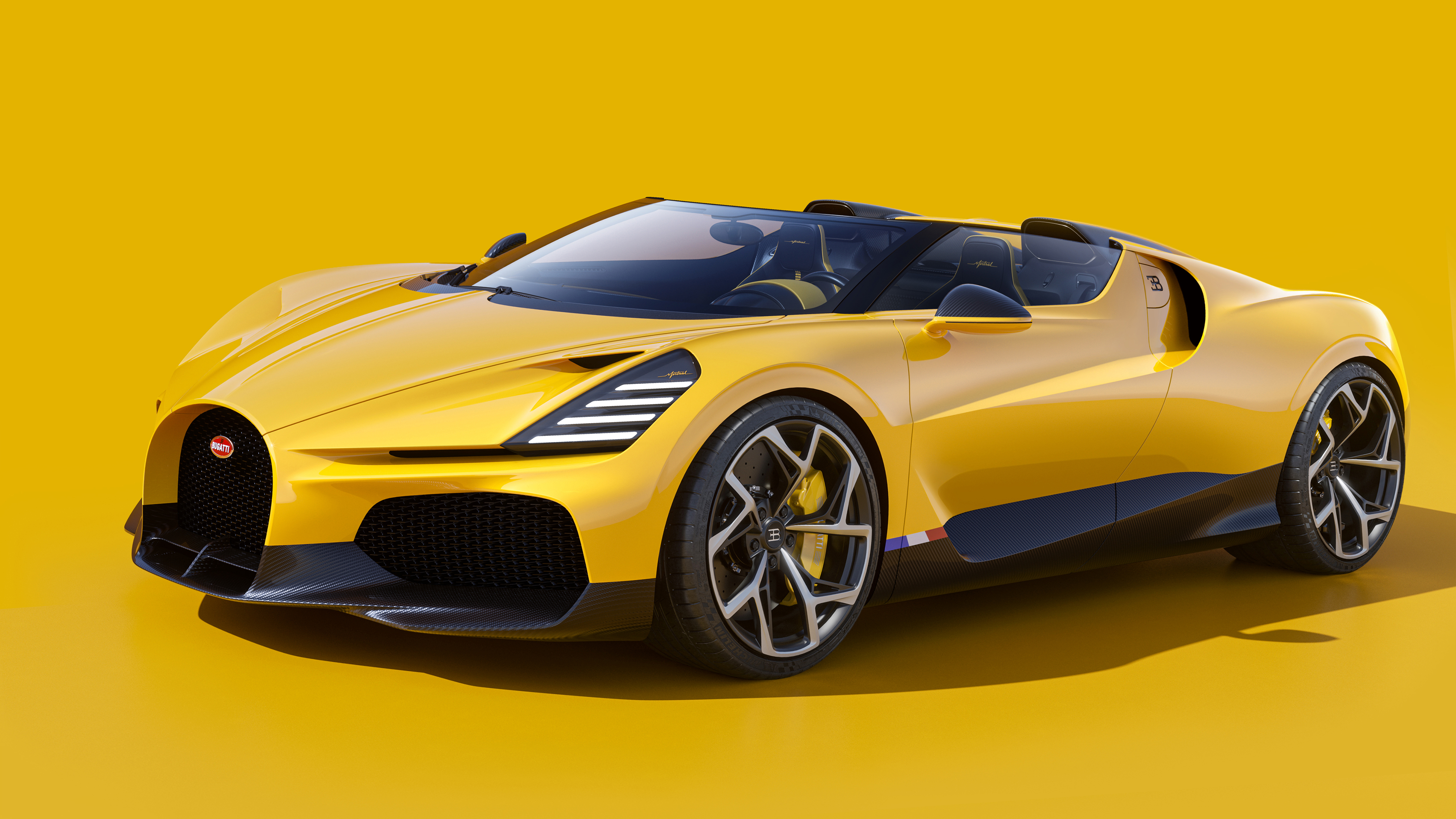 A vibrant yellow Bugatti W16 Mistral roadster against a matching yellow backdrop