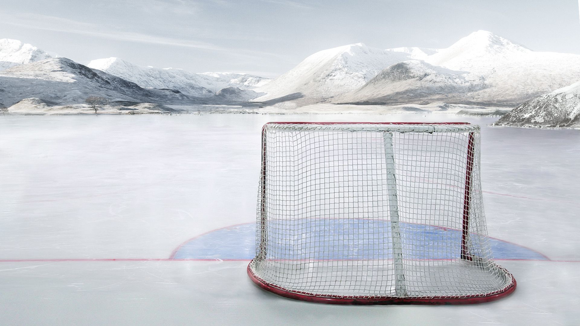 Hockey Net on a Frozen Lake with Snowy Mountains