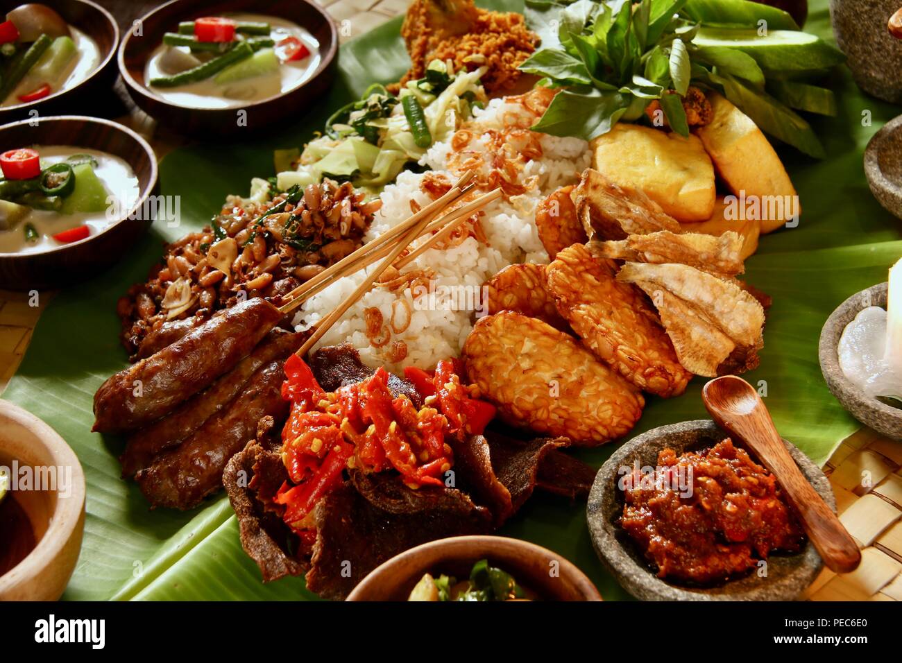 Indonesian Rijsttafel on Banana Leaf Rice with various dishes