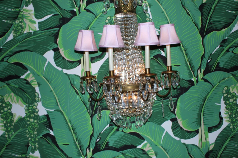 Dainty Pink Chandeliers Paired With Lush Leafy Wallpaper By Carleton