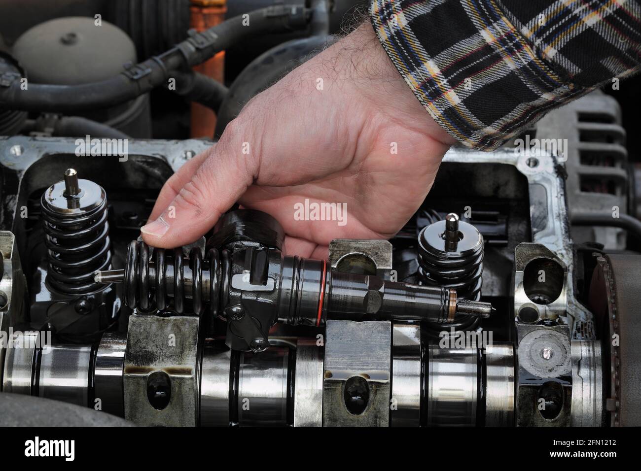 Car Mechanic Fixing Modern Diesel Engine Closeup Of Hand Holding
