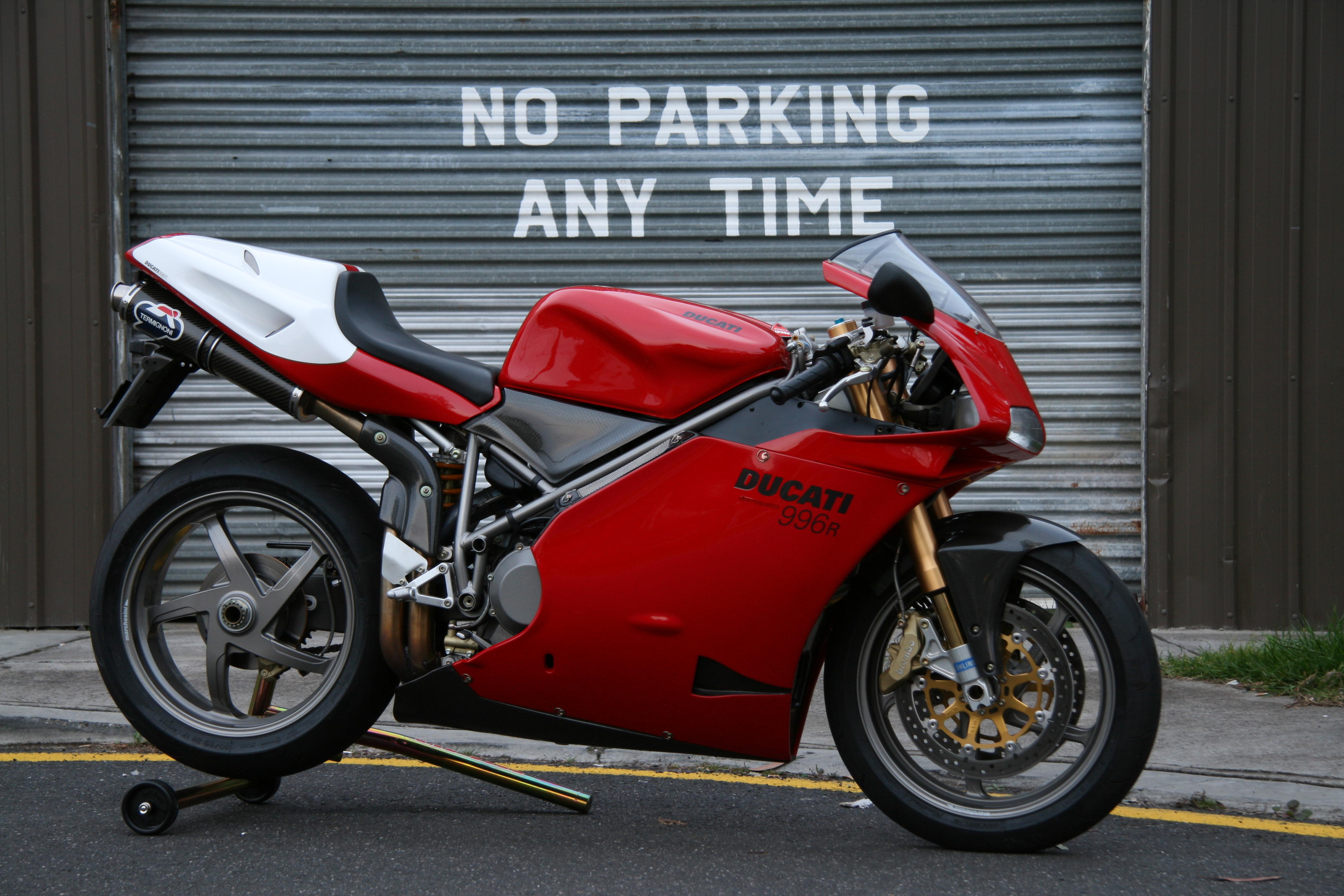 Red Ducati 996R Motorcycle Parked in Front of 