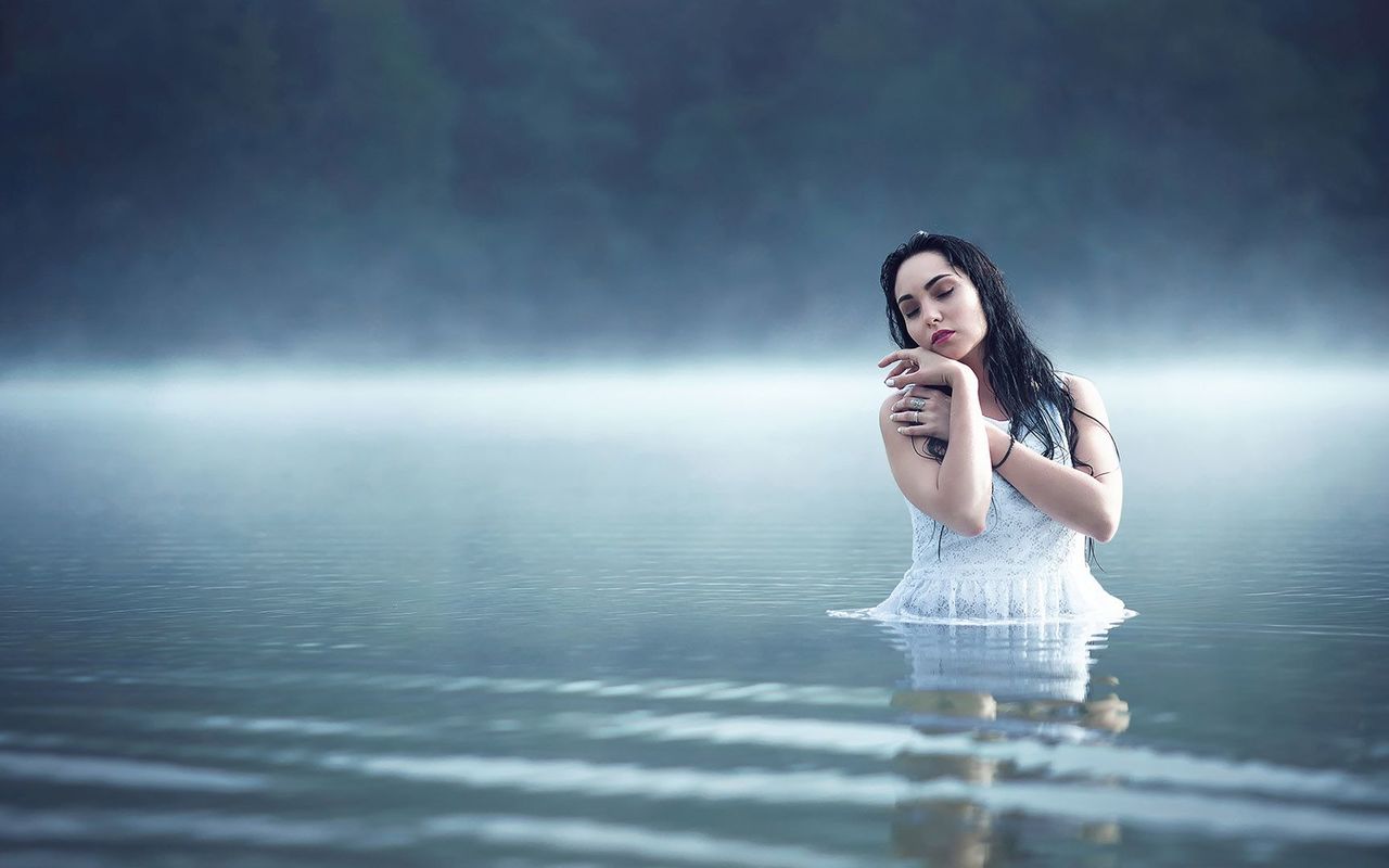Woman in the foggy lake wallpaper
