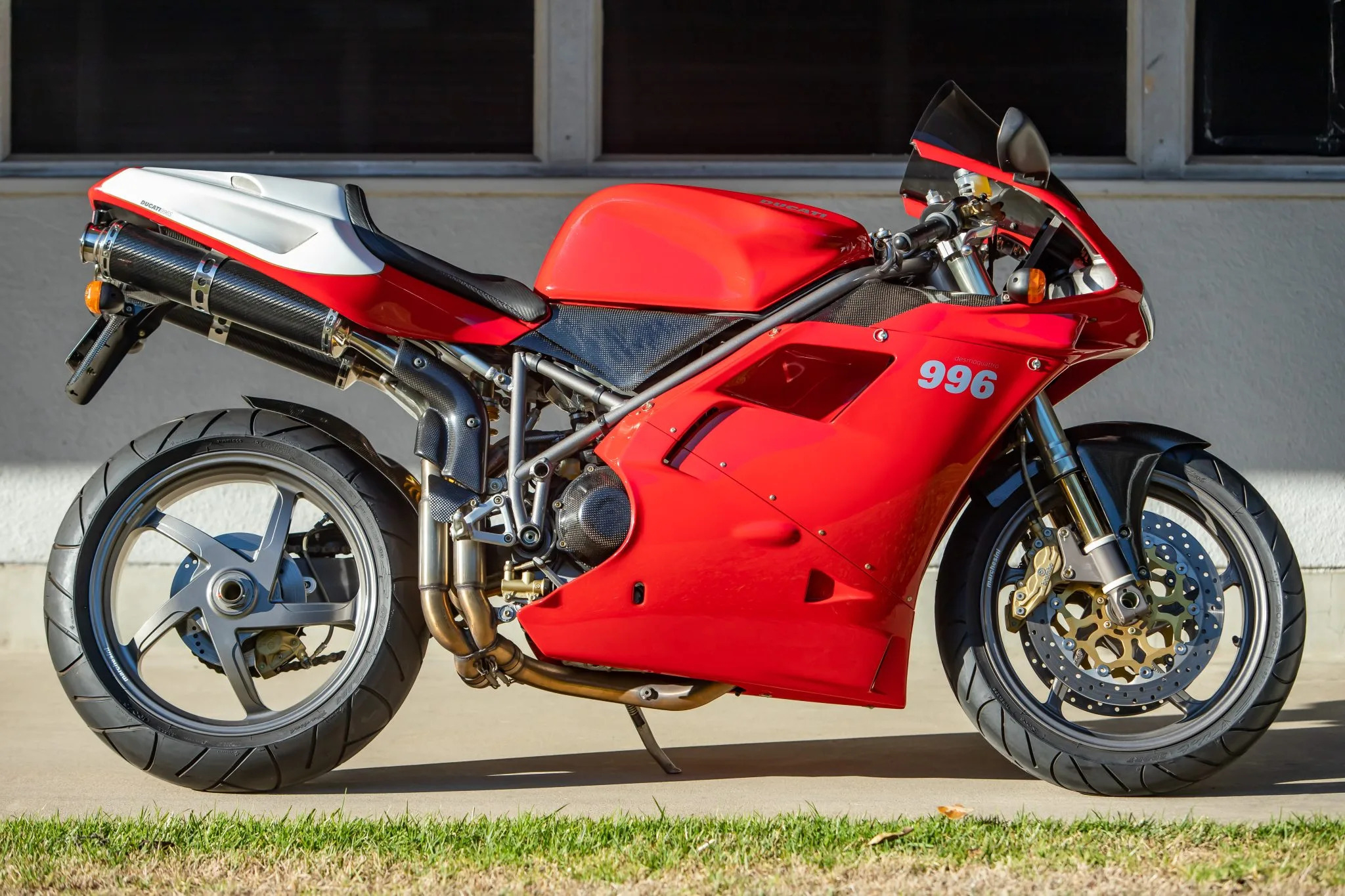 A Ducati 996 motorcycle parked in front of a garage