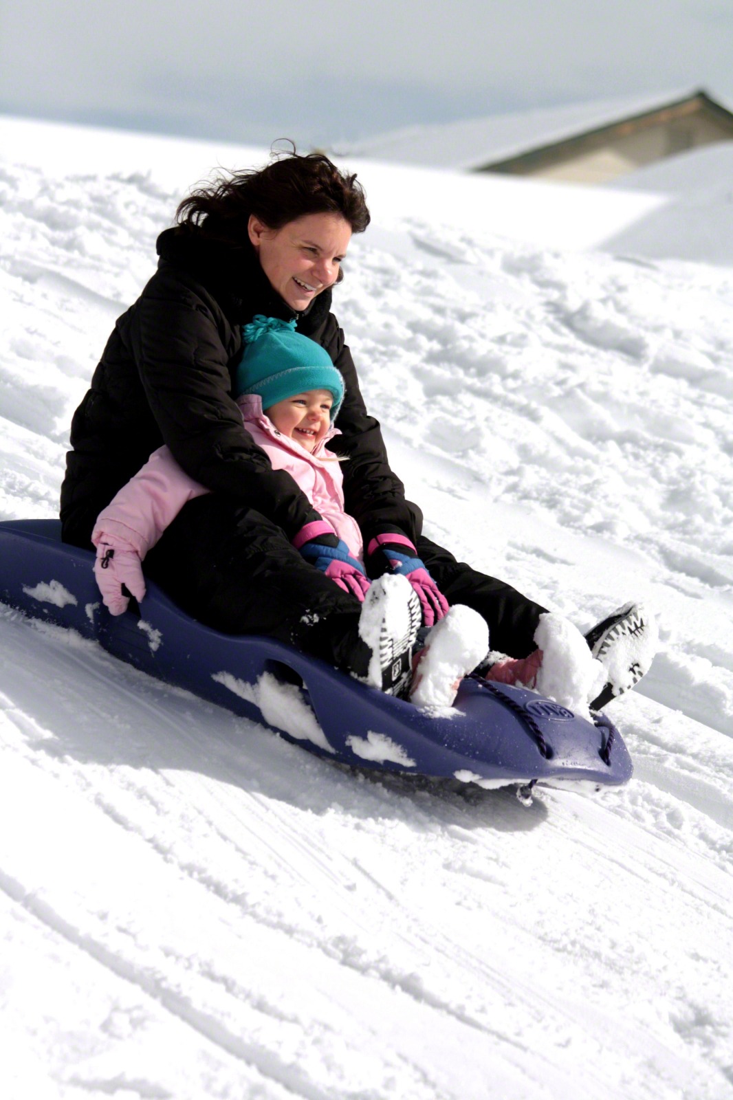 Mother And Daughter Sledding