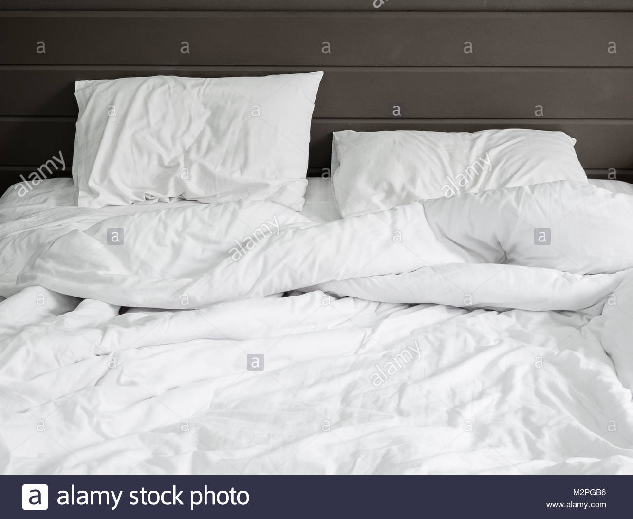 Кровать с белой простыней Сток