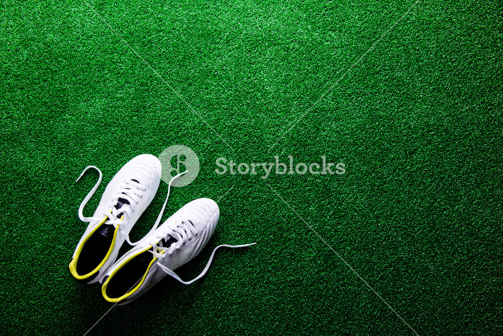 White Cleats Against Artificial Turf Studio Shot On Green
