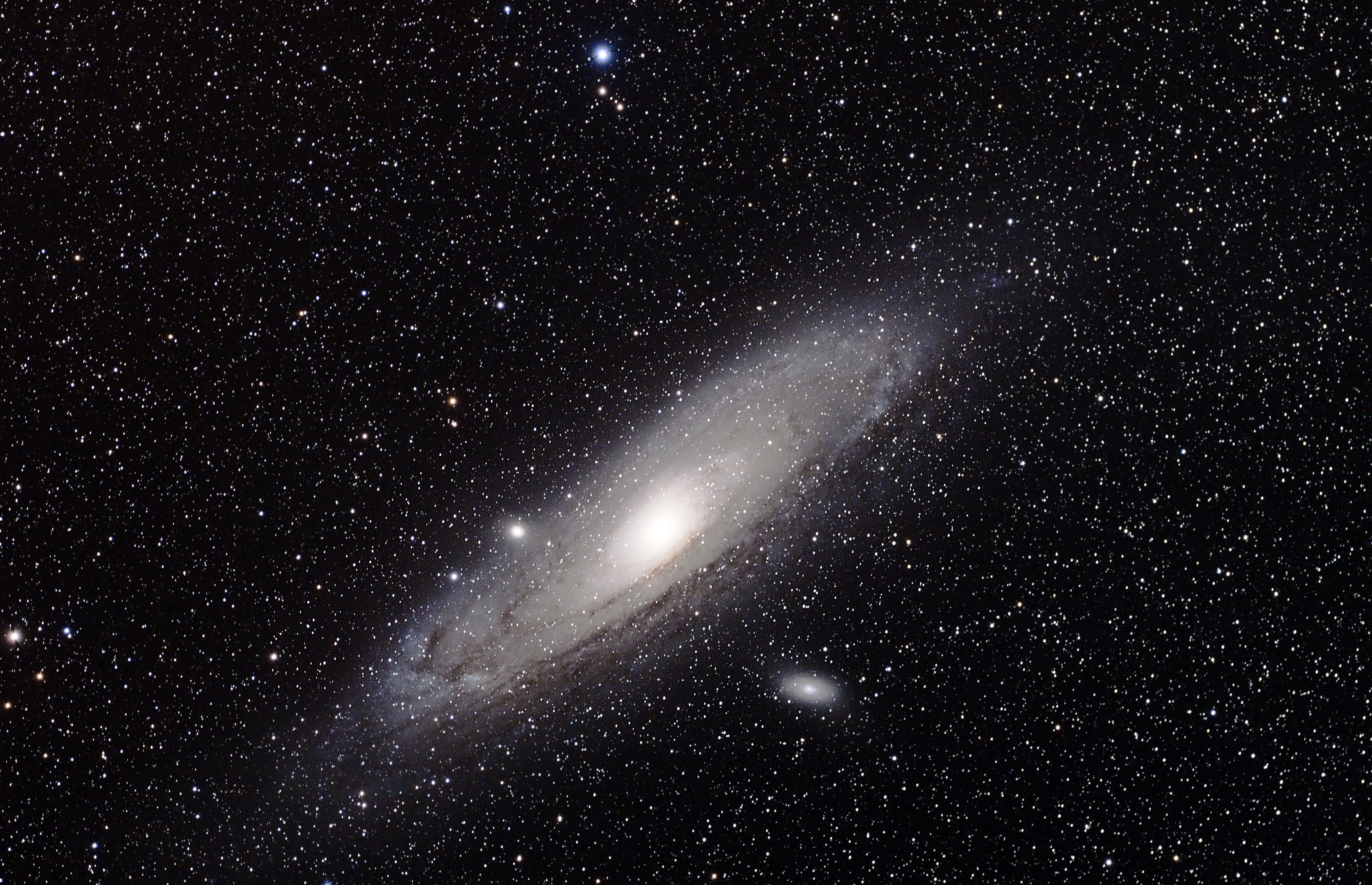 A stunning wallpaper featuring the Andromeda Galaxy, showcasing its spiral arms and bright core against a backdrop of countless stars