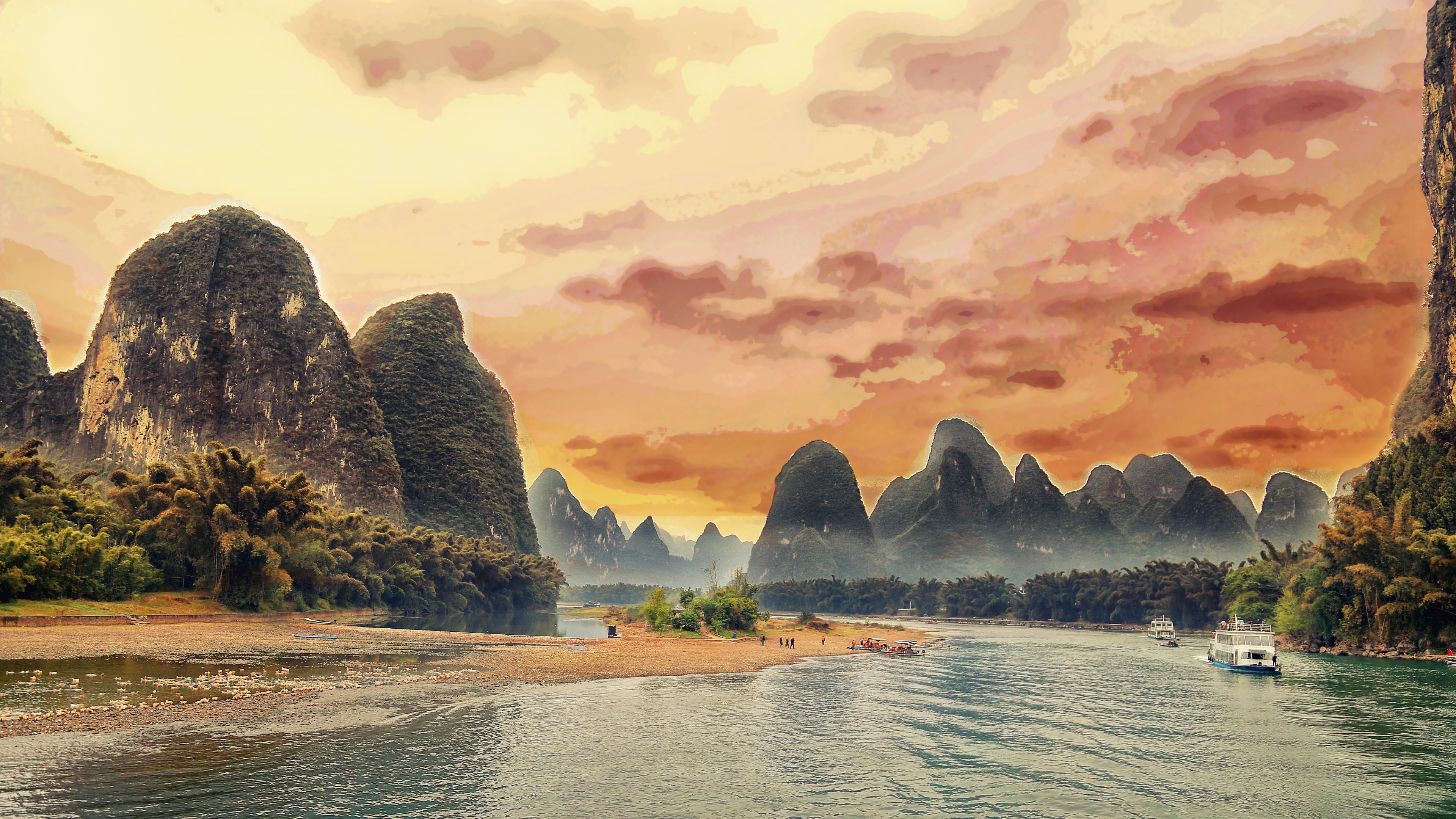 Scenic view of the Li River in Guilin, China, with towering karst mountains and lush vegetation at sunset