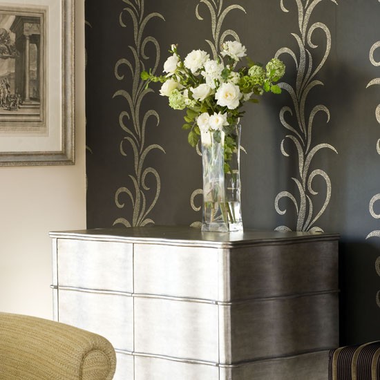 Metallic Feature Wall Against Silvered Chest Of Drawers And Edge