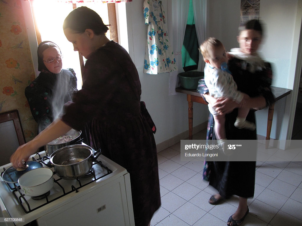 Mennonite Women Cook Food In The Kitchen Of His Home Guatrach