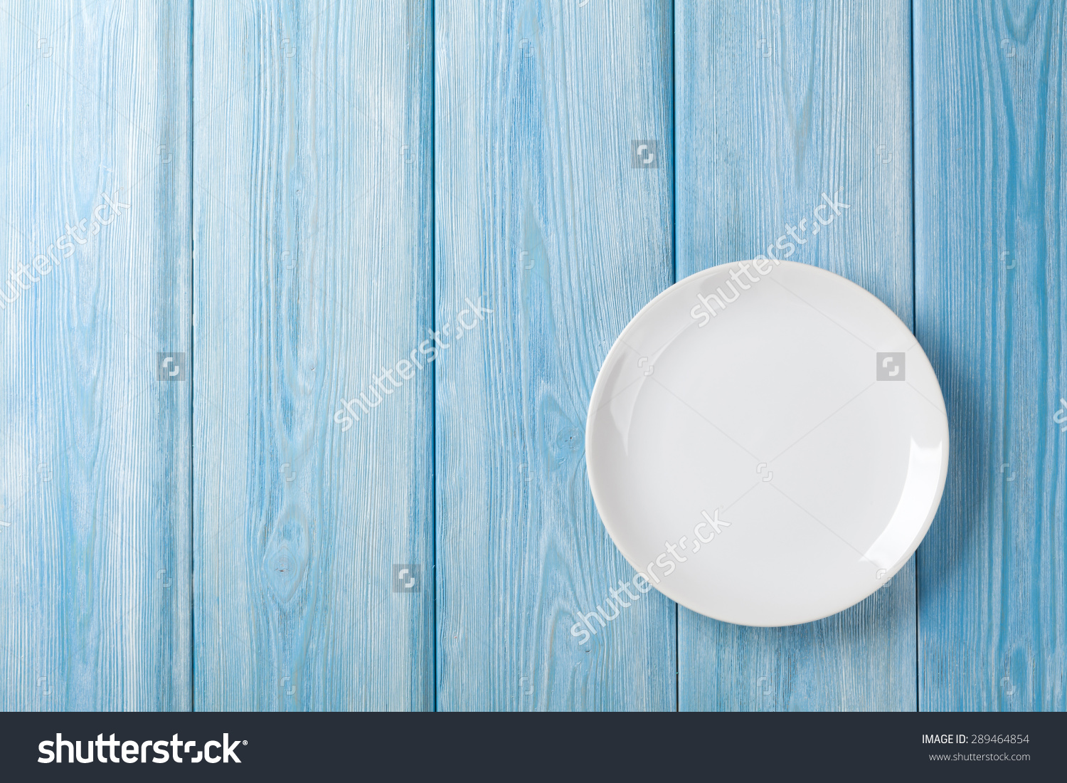 Empty Plate On Blue Wooden Background Top With Copy Space Stock