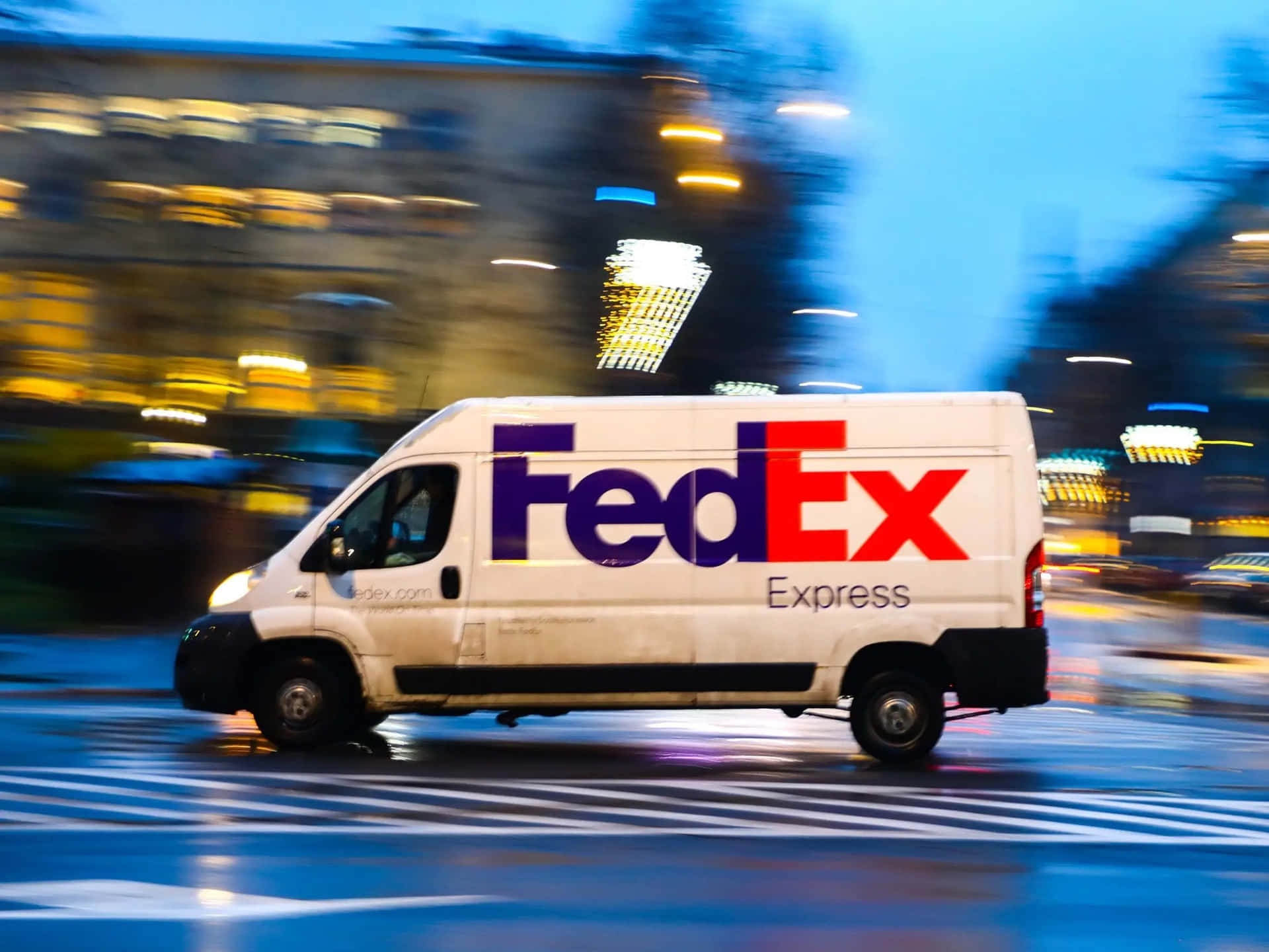 Fedex Express Van Driving Down The Street At Night Wallpaper