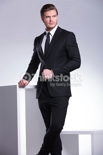 Stock Photo handsome business man leaning on a white table