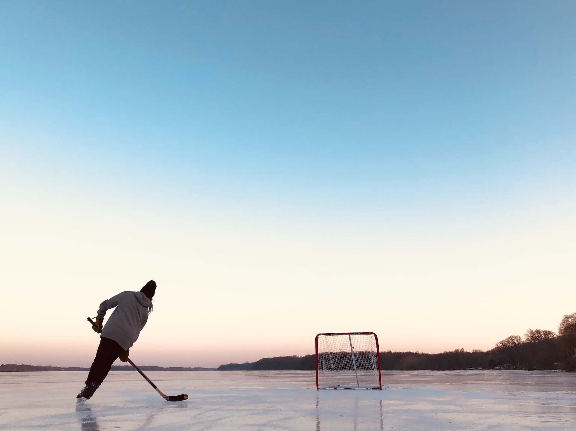 Ice Skaters Enjoying A Winter Day At Public Rink Wallpaper