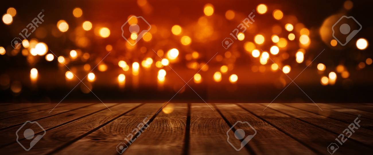 Red Glowing Bokeh Background With Empty Wooden Table For A Solemn