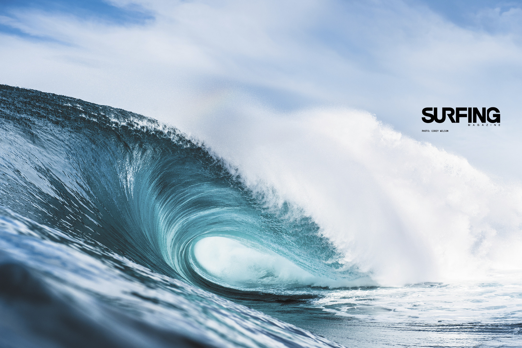 A powerful ocean wave curls into a perfect tube, creating a stunning visual for surfing enthusiasts