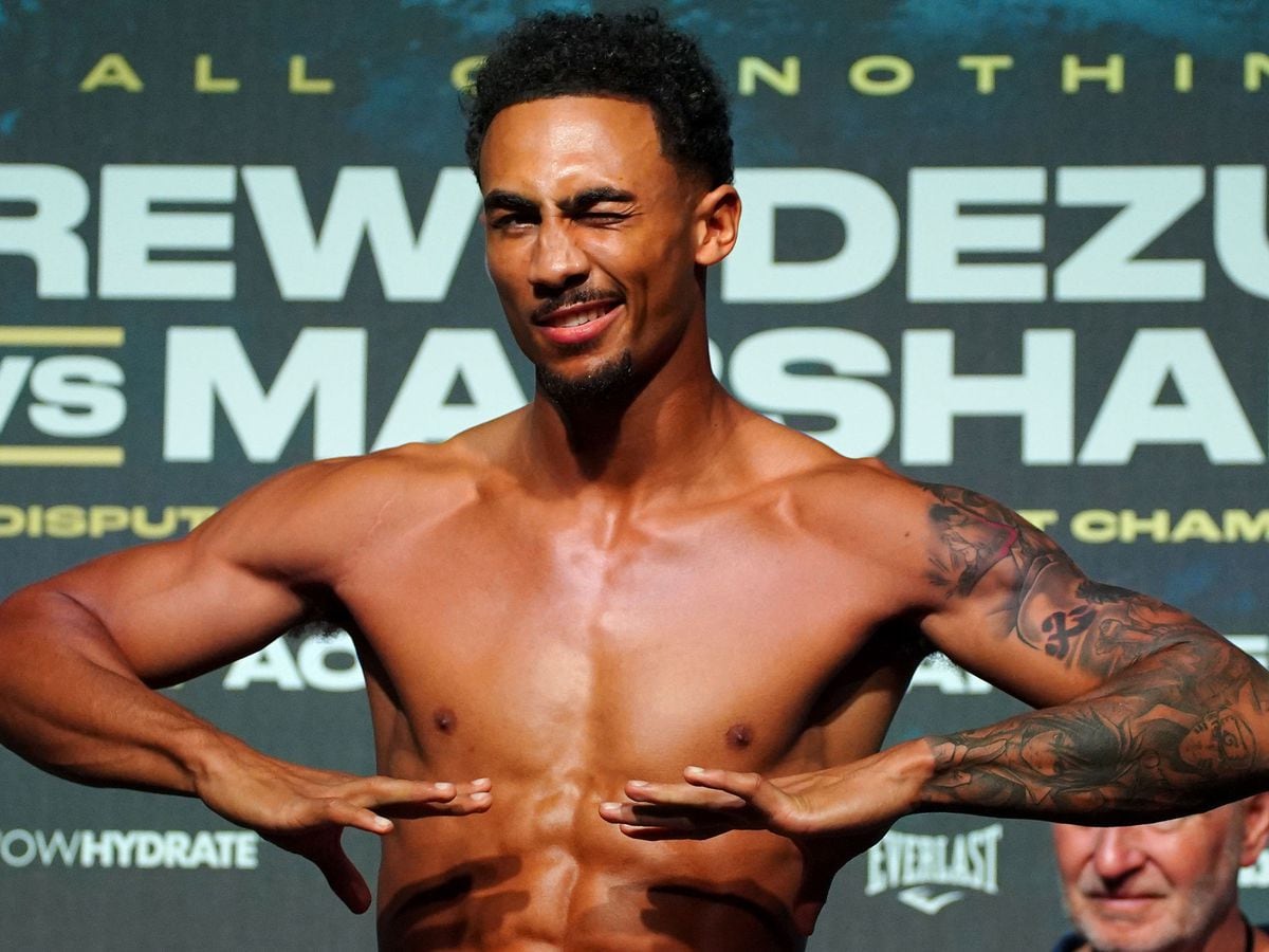 Benjamin Whittaker posing during a weigh-in, showcasing his physique and tattoos