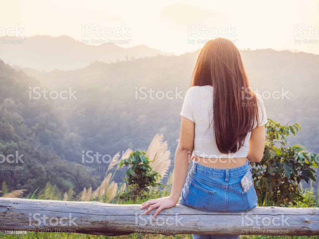 Relaxing In Nature Concept From Backside Of Hipster Girl Sitting