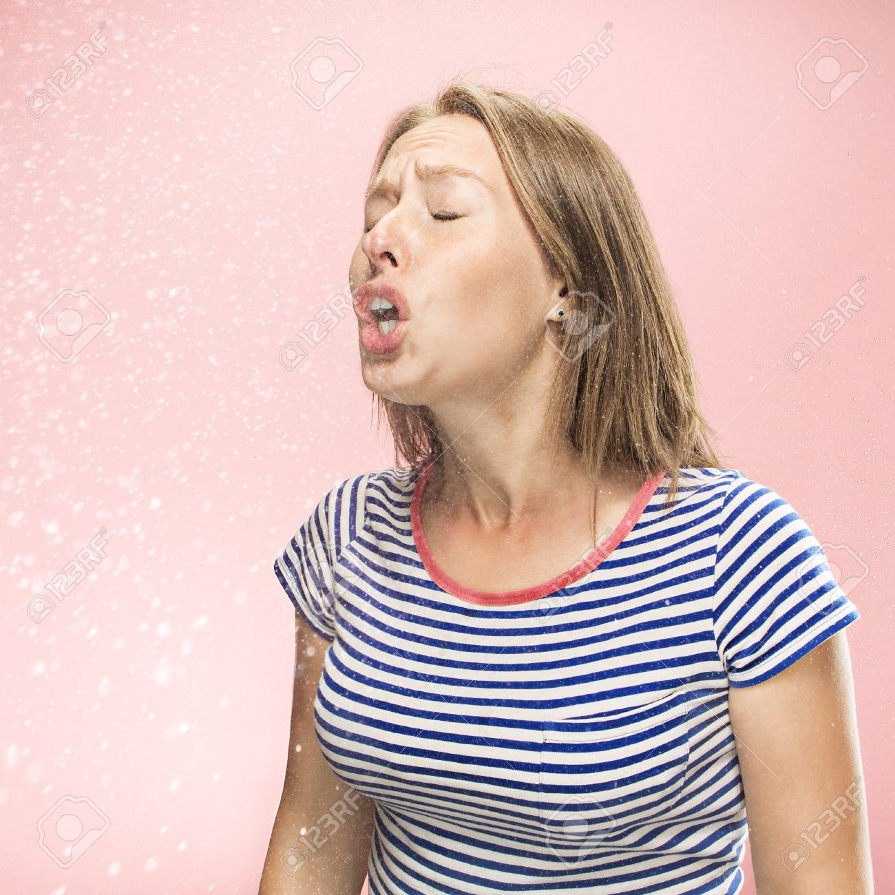 Young Funny Woman Sneezing With Spray And Small Drops Studio