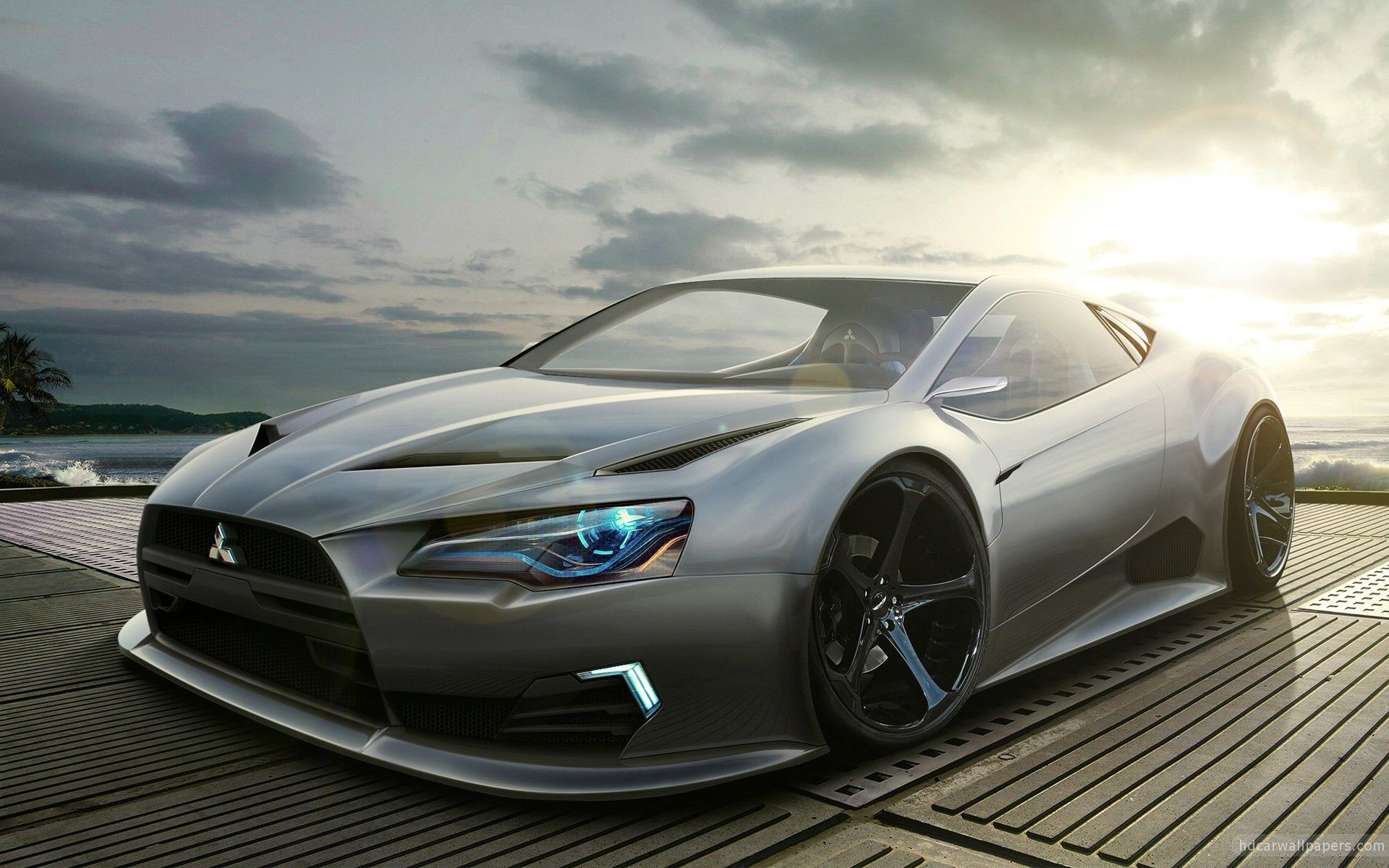 Sleek silver Mitsubishi concept car parked on a pier at sunset