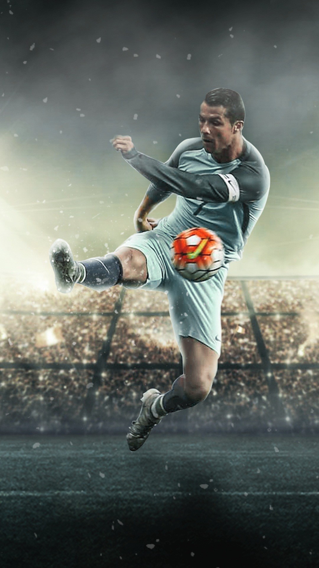 Cristiano Ronaldo kicking a soccer ball mid-air in a packed stadium