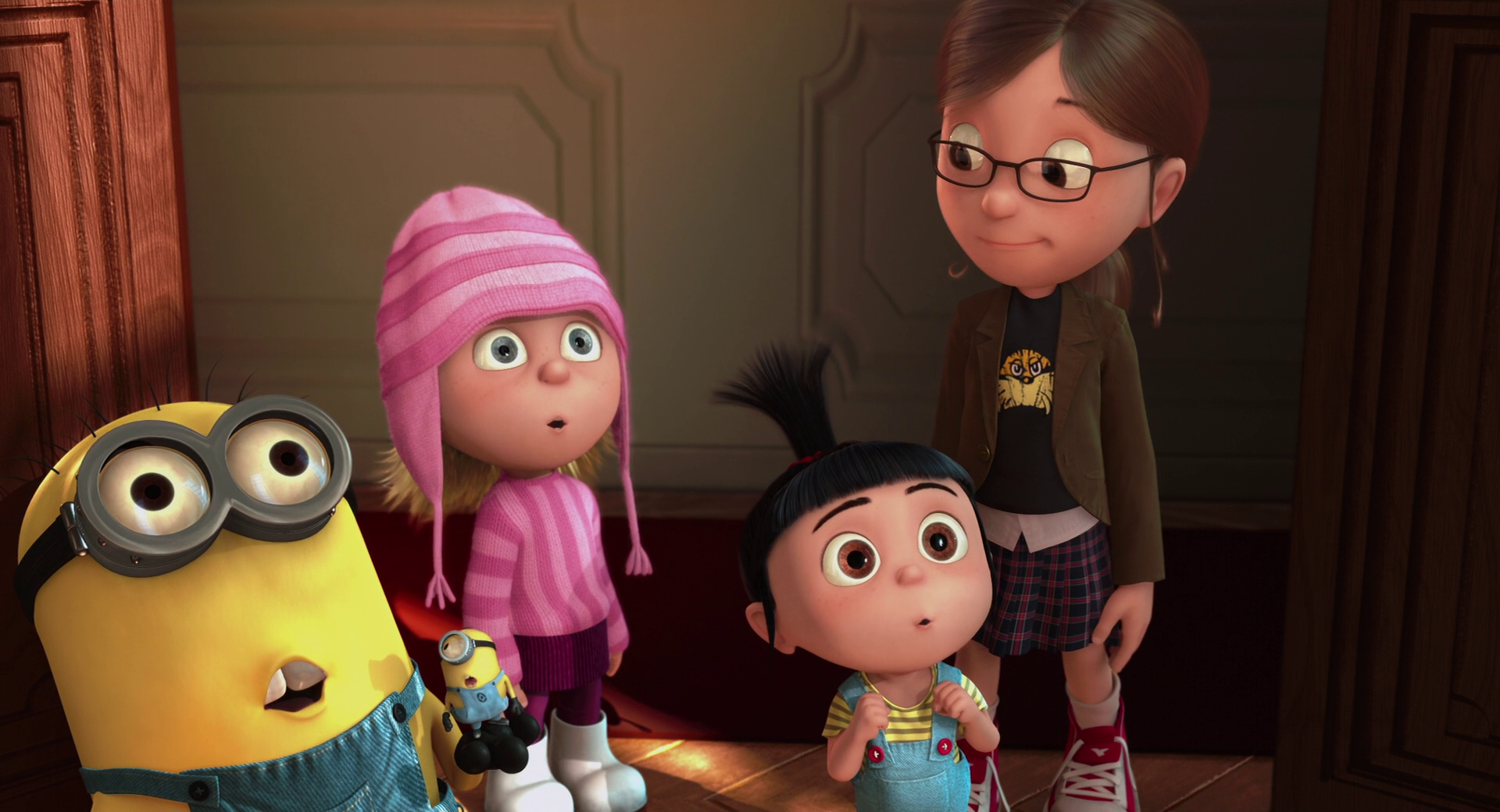 The three girls from Despicable Me, Margo, Edith, and Agnes, stand with a Minion, looking surprised