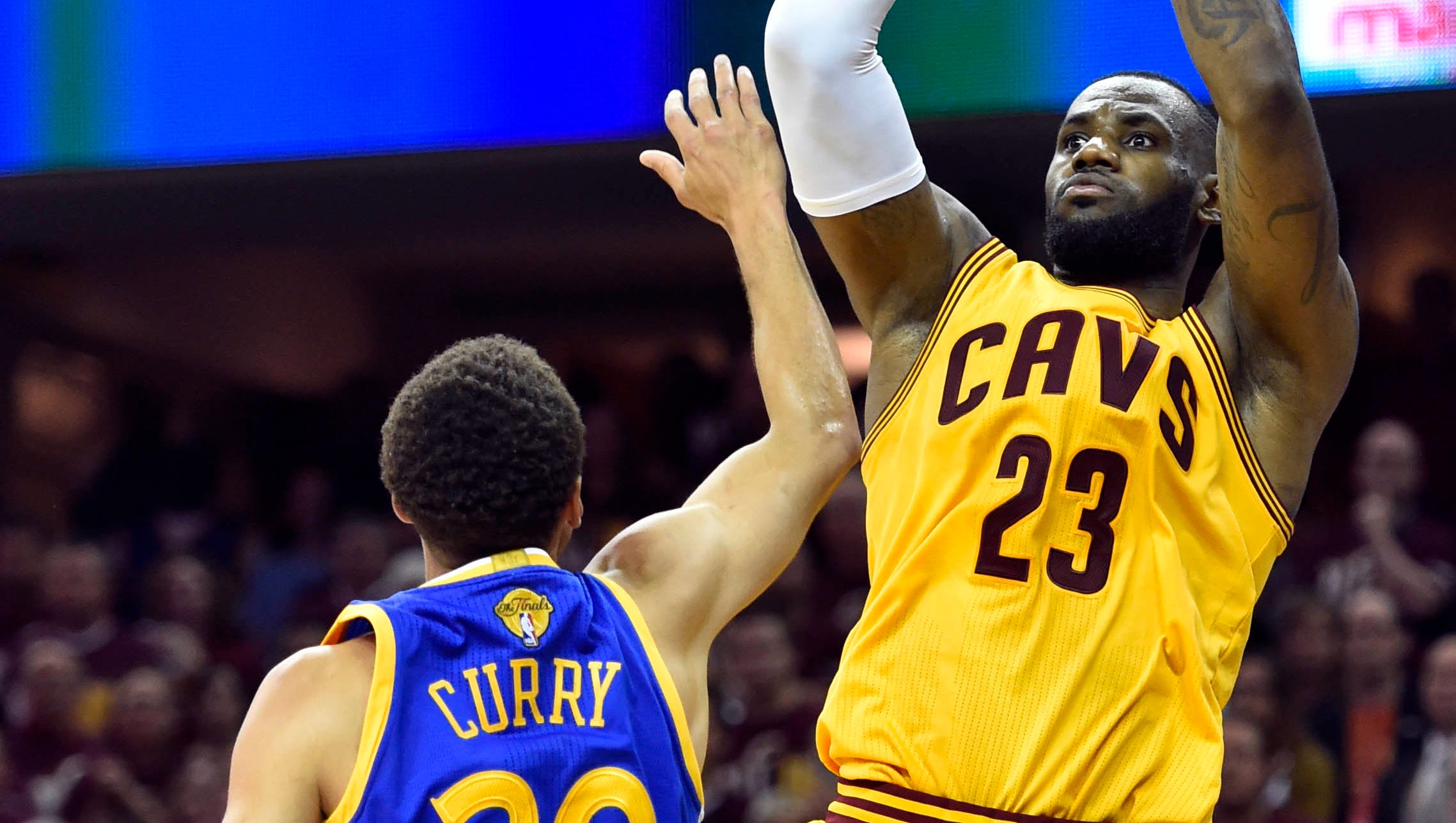 LeBron James and Stephen Curry battling for position during an NBA game