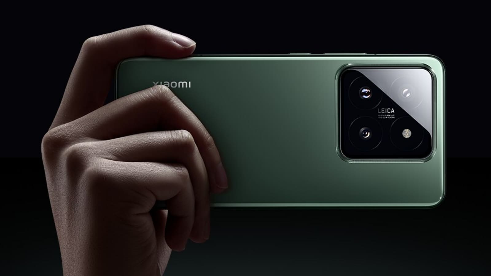 A person holding the Xiaomi 14 Pro, showcasing its green color and Leica camera system