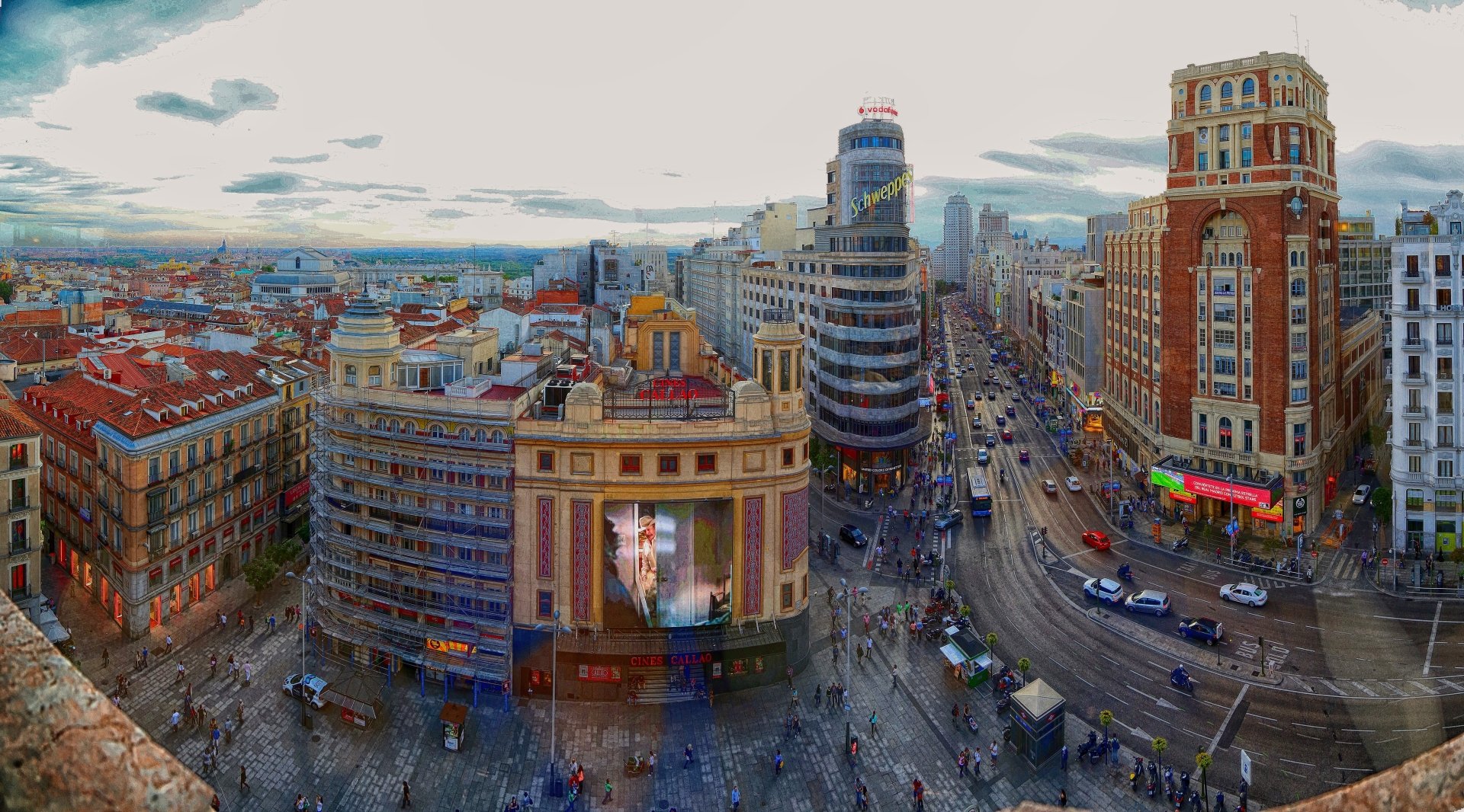 Panoramic view of a bustling city street in Madrid, Spain at dusk