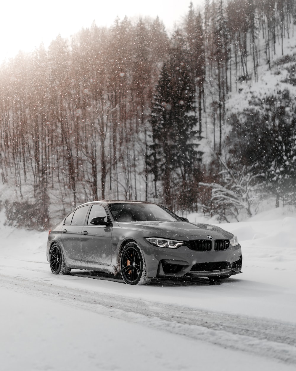 Black Bmw Coupe On Snow Covered Road During Daytime Photo