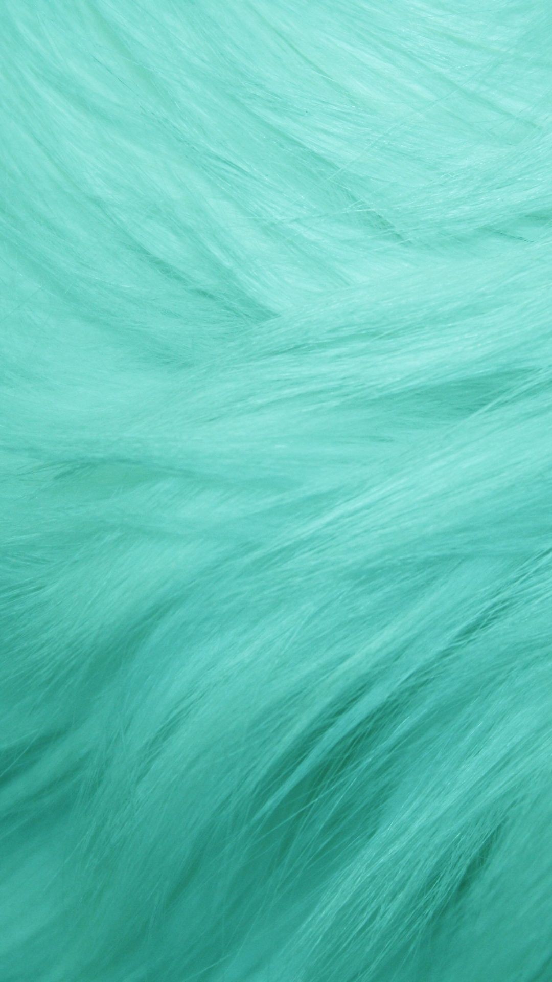 Close-up of mint-colored hair, showcasing its smooth, silky texture and vibrant hue