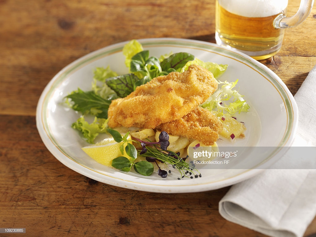 Wiener Schnitzel With Potato Salad On Plate Closeup Stock Photo