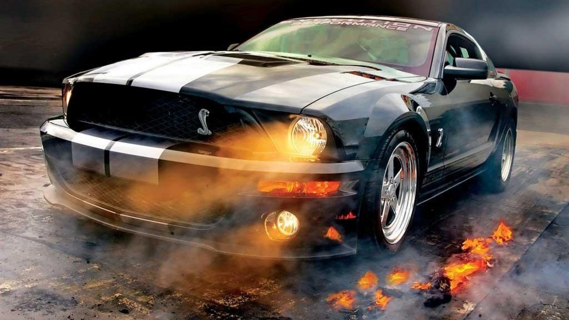 Black and white Ford Mustang Shelby GT500 burning rubber