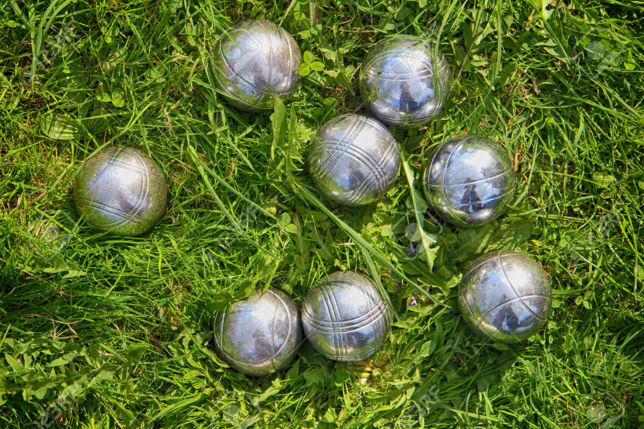 Petanque Bowls In The Green Grass As Sport Background Stock Photo