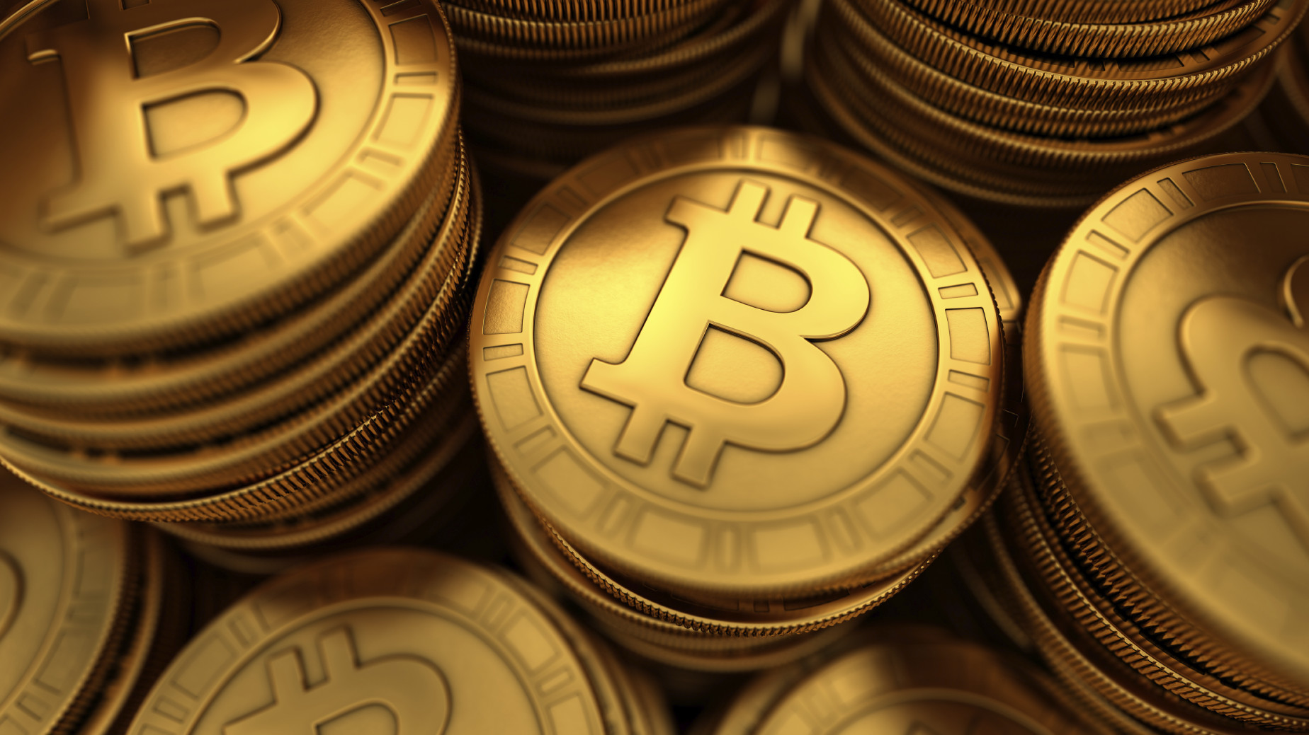Stacks of shiny gold Bitcoin coins, symbolizing the cryptocurrency's value and association with Ross Ulbricht's Silk Road