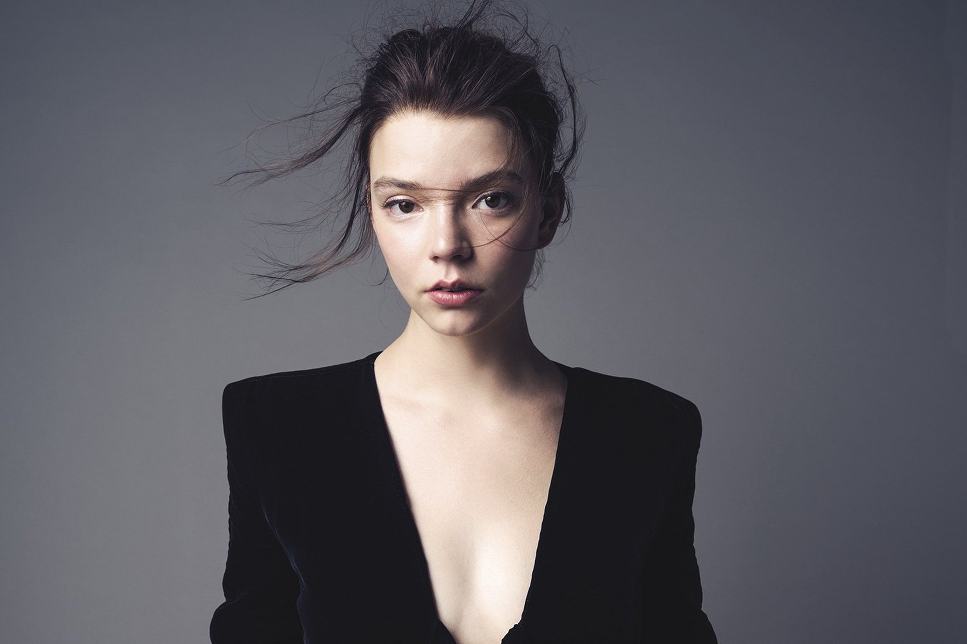 Anya Taylor-Joy in a black velvet jacket, looking directly at the camera