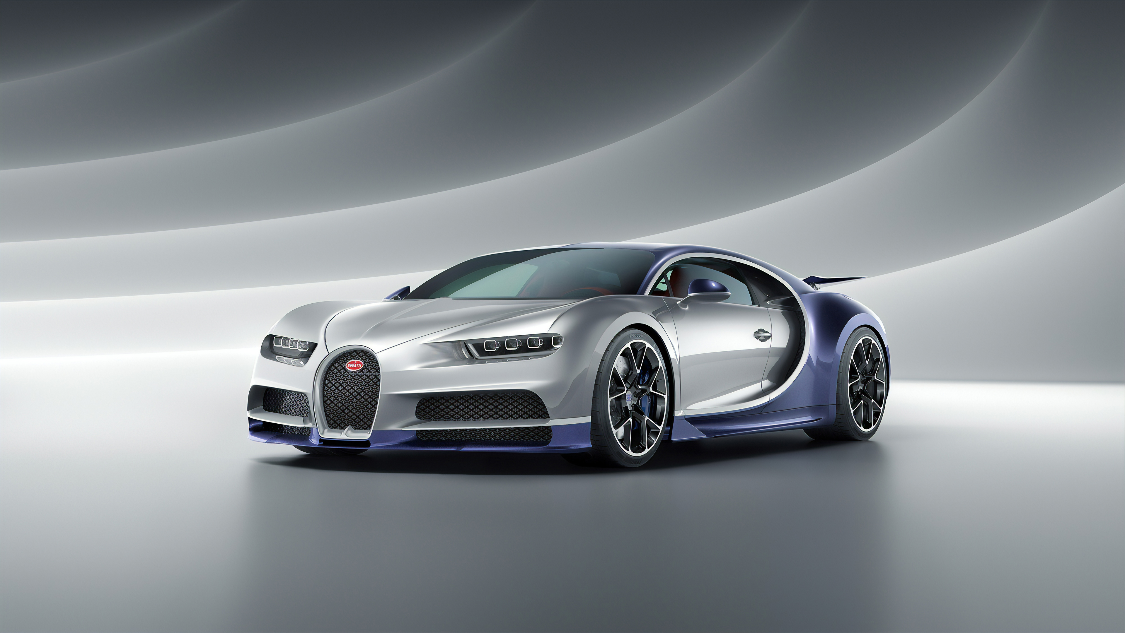 A silver and purple Bugatti Chiron sports car parked in a studio setting
