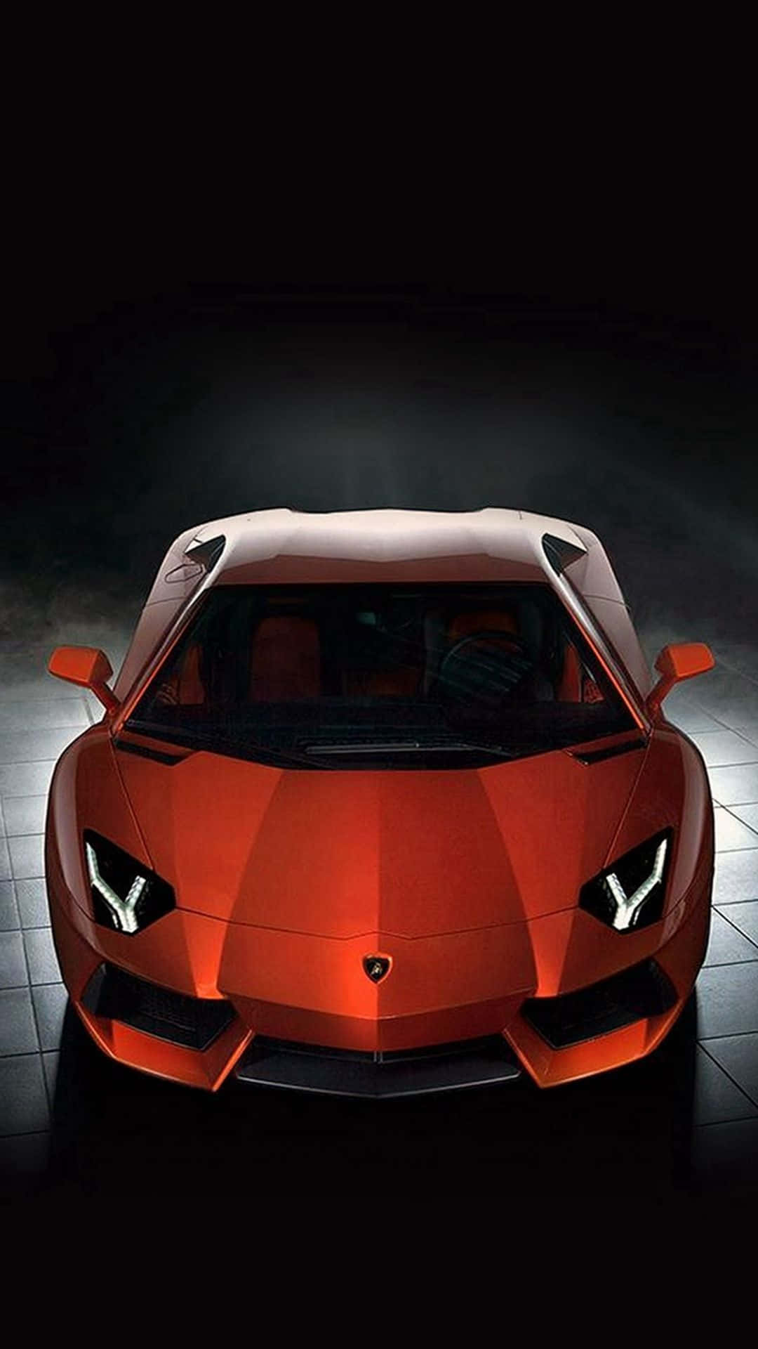 A Red Sports Car Is Shown In Dark Room Wallpaper