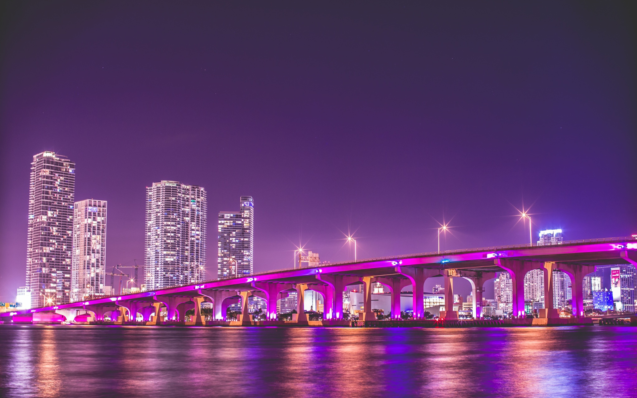 Vibrant Miami Skyline at Night with Illuminated Bridge