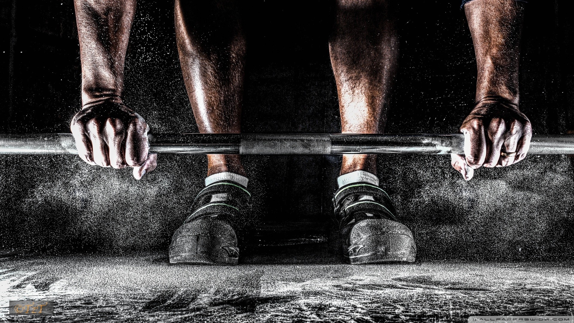 Close-up of a weightlifter's hands gripping a barbell, chalk dust flying, symbolizing strength and CrossFit training